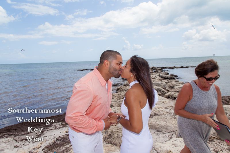 Wedding couple kiss on the beach after getting married in Key West, Florida by Southernmost Weddings