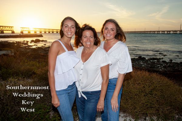 A Family poses for photos at sunset - image by Southernmost Weddings