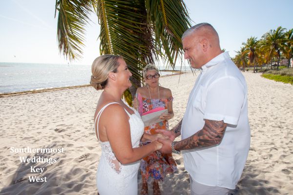 Wedding officiant performs a ceremony on Smathers Beach in Key West, FL.
