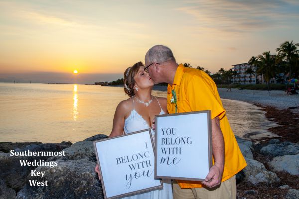 Wedding Couple pose with you belong to me Wedding Signs on Smathers Beach