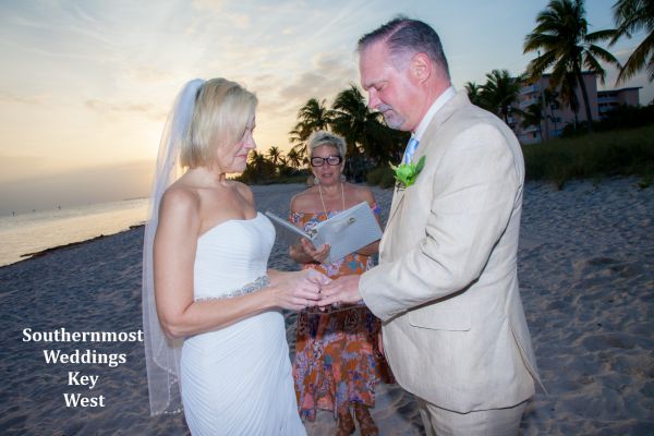 Wedding couple getting married on Smathers Beach in Key West, FL. at Sunset