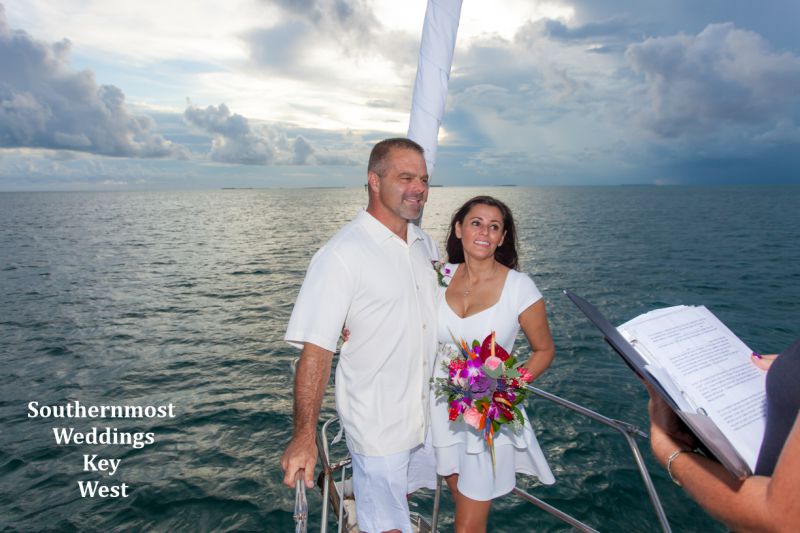 Wedding couple get married on a private sunset sail for just the two of them
