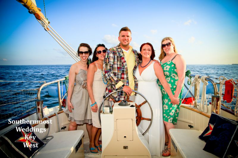 Wedding party celebrate after their wedding on a private sunset sail off the coast of Key West, Florida 