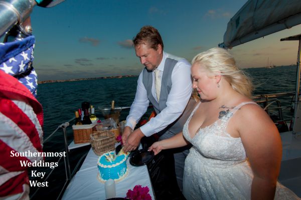Wedding couple celebrate their wedding with some wedding cake after their wedding by Southernmost Weddings