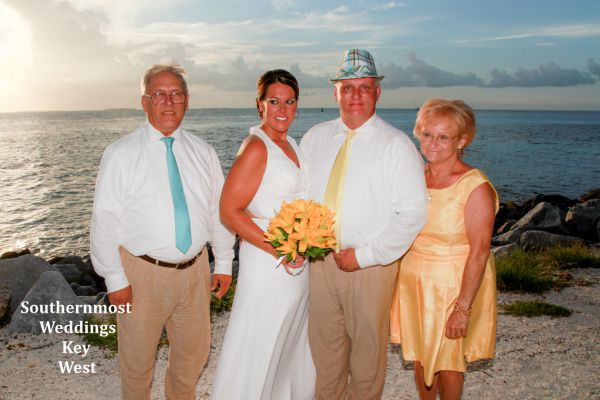 Wedding party poses for photos next to the Gulf of Mexico