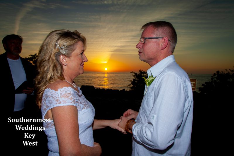 Wedding couple gets married during sunset overlooking the Gulf of Mexico