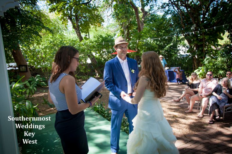 Wedding officiant from Southernmost Weddings marries a couple at the Hemingway House in Key West, Florida