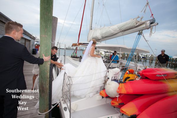 Wedding couple board their private sunset sail catamaran before their wedding by Southernmost Weddings Key West