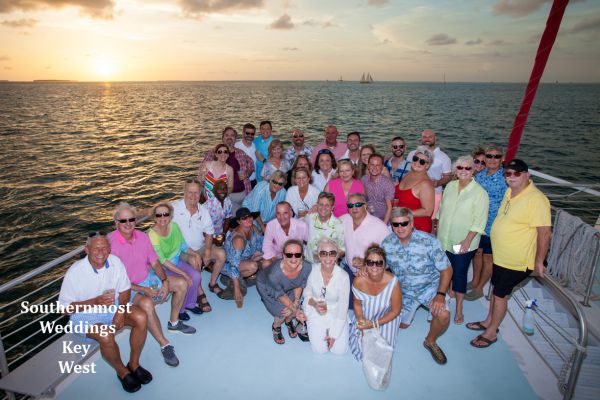 Wedding Party gathers on the bow of the catamaran for photos by Southernmost Weddings Key West
