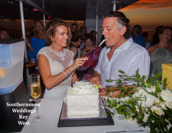 Bride & Groom enjoy some wedding cake after their wedding by Southernmost Weddings Key West
