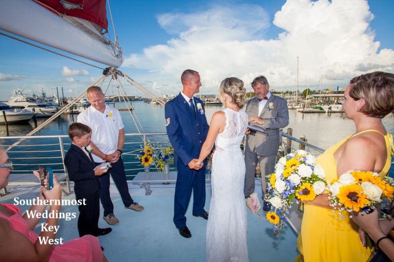 Wedding officiant from Southernmost Weddings marries a couple on a private catamaran before sunset