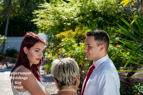 Wedding officiant marries a couple in the Truman Annex Butterfly Garden, Image by Southernmost Weddings  
