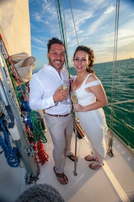 Wedding couple enjoy their private sunset sailboat wedding planned by Southernmost Weddings