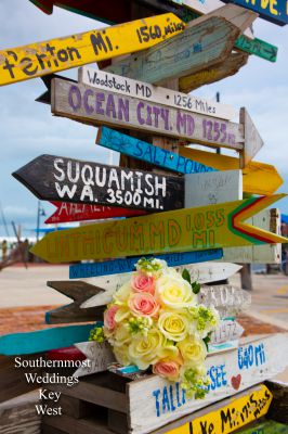 Photo of a Bridal Bouquet next to mile marker signpost by Southernmost Weddings